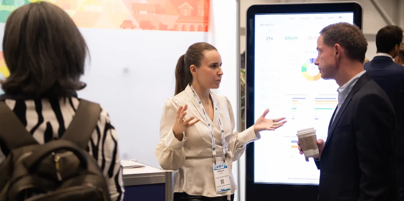 Exhibit at GHGT-18 - Smiling Young Woman talking at the GHGT-17 Conference Exhibition
